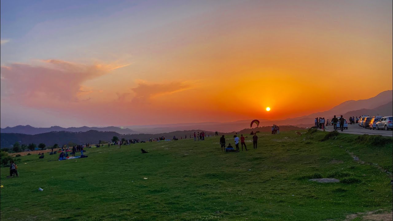 Sunset over the paragliding landing site in Bir-Billing with a glider coming in to land